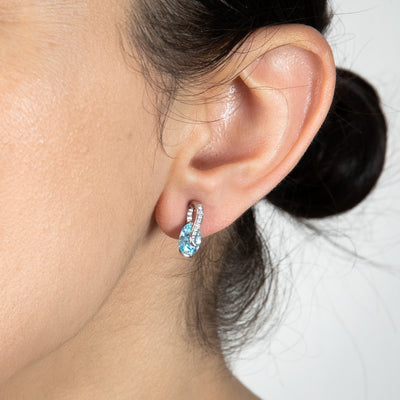 Sterling Silver Rhodium Plated Light Blue And White CZ Crossover Stud Earrings