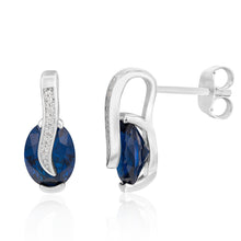 Load image into Gallery viewer, Sterling Silver Rhodium Plated Blue And White Cubic Zirconia Crossove Stud Earrings